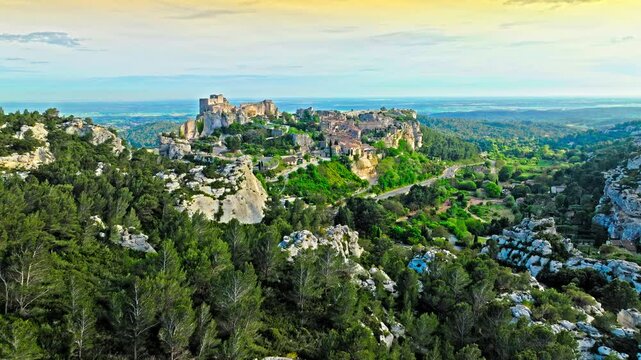 Aerial view of Medieval fortress ruins with replica siege engines in France. Les Baux de Provence village is on the rock formation, and its castle Ch&acirc;teau des Baux-de-Provence in France.