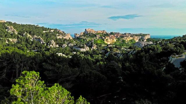Aerial view of Medieval fortress ruins with replica siege engines in France. Les Baux de Provence village is on the rock formation, and its castle Ch&acirc;teau des Baux-de-Provence in France.