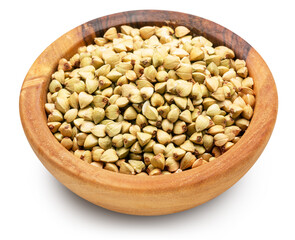 Wooden bowl of raw buckwheat on white background. File contains clipping path. Top view.