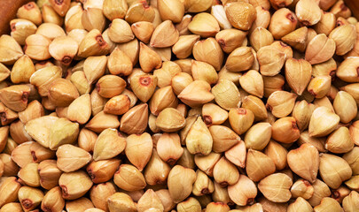 Hulled kernels of buckwheat grains close up. Food background.