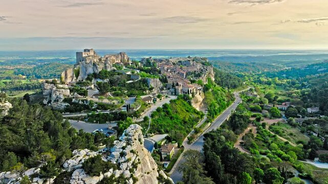 Aerial view of Medieval fortress ruins with replica siege engines in France. Les Baux de Provence village is on the rock formation, and its castle Ch&acirc;teau des Baux-de-Provence in France.