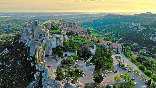 Aerial view of Medieval fortress ruins with replica siege engines in France. Les Baux de Provence village is on the rock formation, and its castle Ch&acirc;teau des Baux-de-Provence in France.