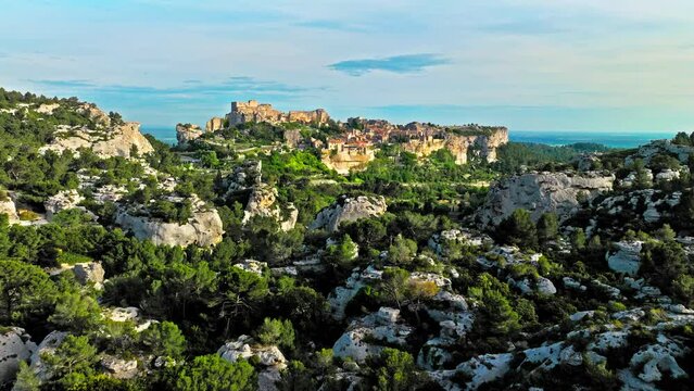 Aerial view of Medieval fortress ruins with replica siege engines in France. Les Baux de Provence village is on the rock formation, and its castle Ch&acirc;teau des Baux-de-Provence in France.