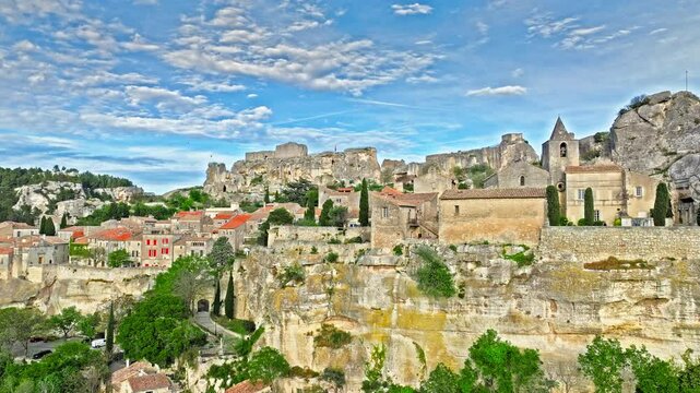 Aerial view of Medieval fortress ruins with replica siege engines in France. Les Baux de Provence village is on the rock formation, and its castle Ch&acirc;teau des Baux-de-Provence in France.