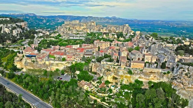 Aerial view of Medieval fortress ruins with replica siege engines in France. Les Baux de Provence village is on the rock formation, and its castle Ch&acirc;teau des Baux-de-Provence in France.