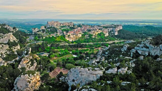 Aerial view of Medieval fortress ruins with replica siege engines in France. Les Baux de Provence village is on the rock formation, and its castle Ch&acirc;teau des Baux-de-Provence in France.