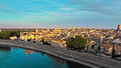 View from above of Arles city with Rhône River view at golden sunset. Panoramic view of ancient town Arles in Provence and Cote d'Azur, France, South Europe. 
