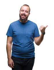 Naklejka premium Young caucasian hipster man over isolated background smiling with happy face looking and pointing to the side with thumb up.