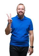 Young caucasian hipster man wearing blue shirt over isolated background showing and pointing up with fingers number two while smiling confident and happy.