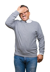 Middle age bussines arab man wearing glasses over isolated background smiling and laughing with hand on face covering eyes for surprise. Blind concept.