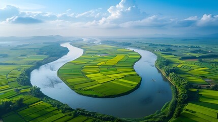 Aerial View of Winding River Surrounded by Lush Green Farmland Countryside Landscape
