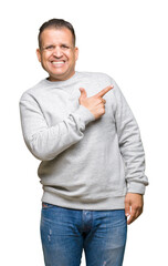 Middle age arab man wearing sport sweatshirt over isolated background cheerful with a smile of face pointing with hand and finger up to the side with happy and natural expression on face