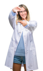 Young beautiful doctor woman headphones over isolated background smiling making frame with hands and fingers with happy face. Creativity and photography concept.
