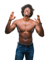 Afro american shirtless man showing nude body over isolated background smiling crossing fingers with hope and eyes closed. Luck and superstitious concept.