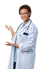 Young african american doctor woman wearing medical coat over isolated background Inviting to enter smiling natural with open hand