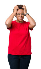 Beautiful young african american woman wearing glasses over isolated background suffering from headache desperate and stressed because pain and migraine. Hands on head.