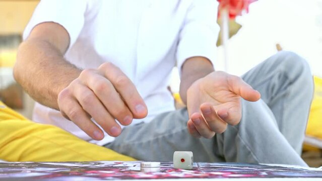 Man's Hands Close-Up Throwing Die on Playing Field and Makes Move as Chip to Through Leela's Game.