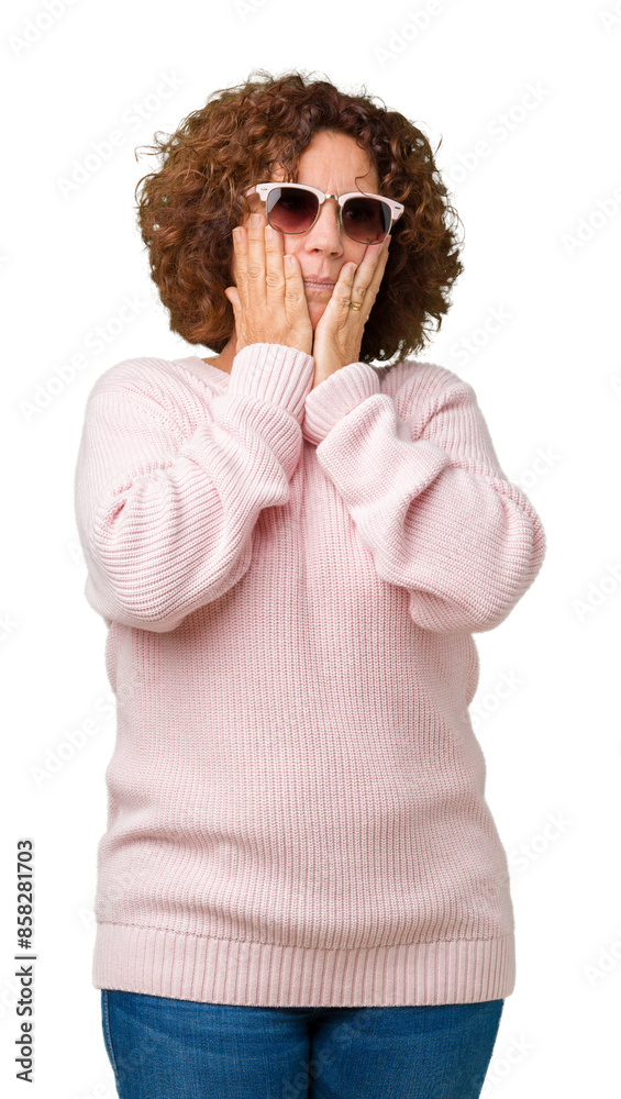 Wall mural Beautiful middle ager senior woman wearing pink sweater and sunglasses over isolated background Tired hands covering face, depression and sadness, upset and irritated for problem