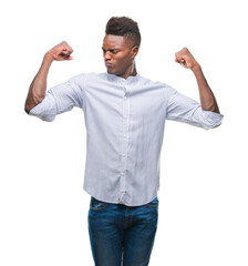 Young african american man over isolated background showing arms muscles smiling proud. Fitness concept.