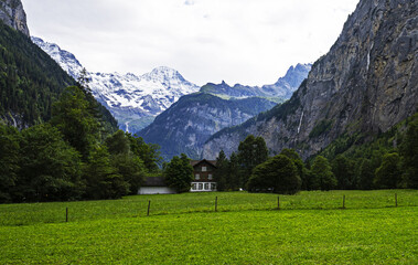 Valley of waterfalls in Switzerland with Alps moutains in the background