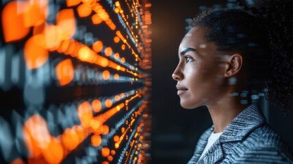 Focused woman analyzing data visualization on a digital display, representing technology and innovation in modern business.