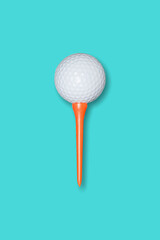 Picture of a golf ball and orange golf tee.
