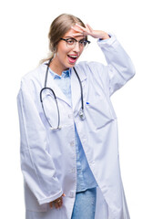 Beautiful young blonde doctor woman wearing medical uniform over isolated background very happy and smiling looking far away with hand over head. Searching concept.