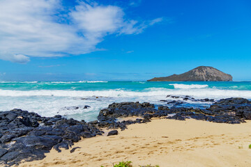 A serene beach with a small island visible in the background