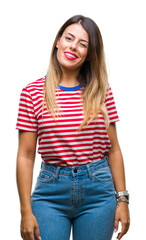 Fototapeta premium Young beautiful woman casual look over isolated background winking looking at the camera with sexy expression, cheerful and happy face.