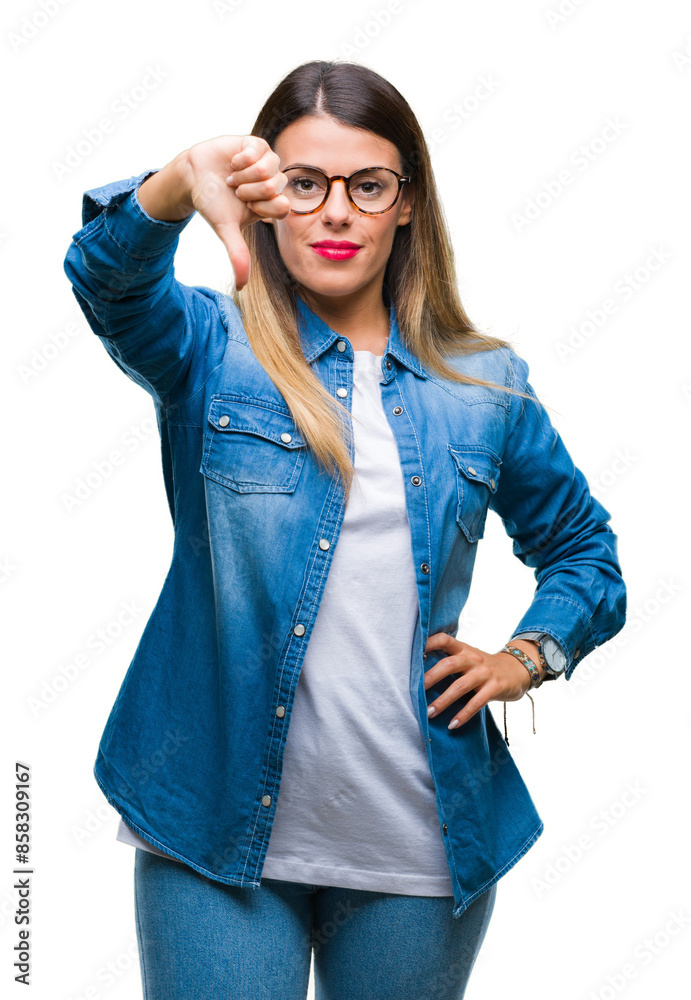 Poster Young beautiful woman over wearing glasses over isolated background looking unhappy and angry showing rejection and negative with thumbs down gesture. Bad expression.