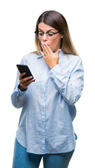 Young beautiful business woman texting message using smartphone over isolated background cover mouth with hand shocked with shame for mistake, expression of fear, scared in silence, secret concept