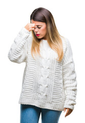 Young beautiful woman casual white sweater over isolated background tired rubbing nose and eyes feeling fatigue and headache. Stress and frustration concept.