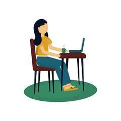 Girl sitting at a table using a computer
