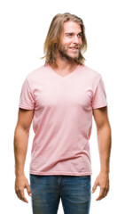 Fototapeta premium Young handsome man with long hair over isolated background looking away to side with smile on face, natural expression. Laughing confident.