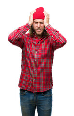 Young handsome man with long hair wearing red cap over isolated background suffering from headache desperate and stressed because pain and migraine. Hands on head.