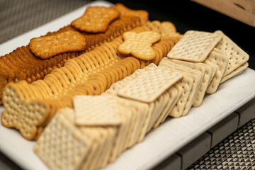 Plate of different crackers, variety of salty snacks