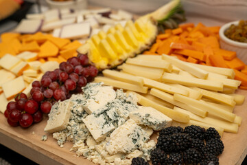 Cheese board at an event with variety of fruit and cheese. Cheese plate at a get together