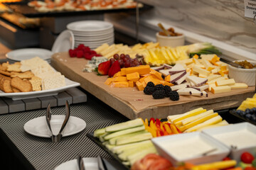Cheese board at an event with variety of fruit and cheese. Cheese plate at a get together