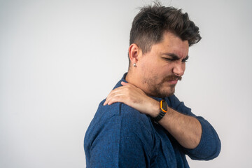 Man back neck and shoulder pain, inflammation of muscles and ligaments rupture during sports, inflammation and injury, in a blue shirt isolated