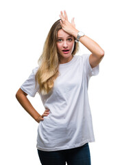 Young beautiful blonde woman wearing casual white t-shirt over isolated background surprised with...