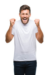 Naklejka premium Young handsome man over isolated background excited for success with arms raised celebrating victory smiling. Winner concept.
