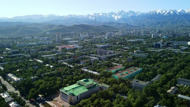 Aerial view of the Abai Opera and Ballet Theater in the early morning. Aerial view of the historical center of Almaty with the main attractions of the city and views of the mountains. 