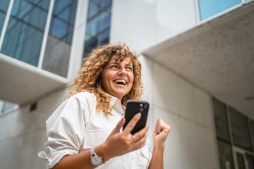 Portrait of adult woman stand in front business build use mobile phone