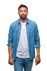 Fototapeta premium Adult hispanic man over isolated background with serious expression on face. Simple and natural looking at the camera.