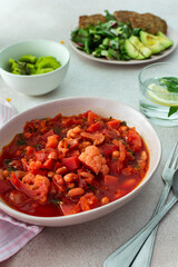 Red soup with beet, vegetables and cauliflower, chickpea cutlets and mixed salad with avocado, delicious hearty breakfasts or lunches, a set table with food
