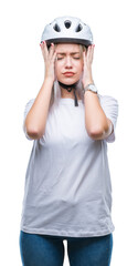 Young blonde woman wearing cyclist security helmet over isolated background suffering from headache desperate and stressed because pain and migraine. Hands on head.