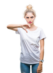 Young beautiful blonde woman wearing white t-shirt over isolated background looking unhappy and angry showing rejection and negative with thumbs down gesture. Bad expression.