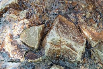 close up of natural rock surface large chunks brown tan orange