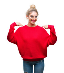 Young beautiful blonde woman wearing red sweater and glasses over isolated background looking...