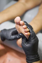 Fototapeta premium Podiatrist treating feet with massage, concept chiropody